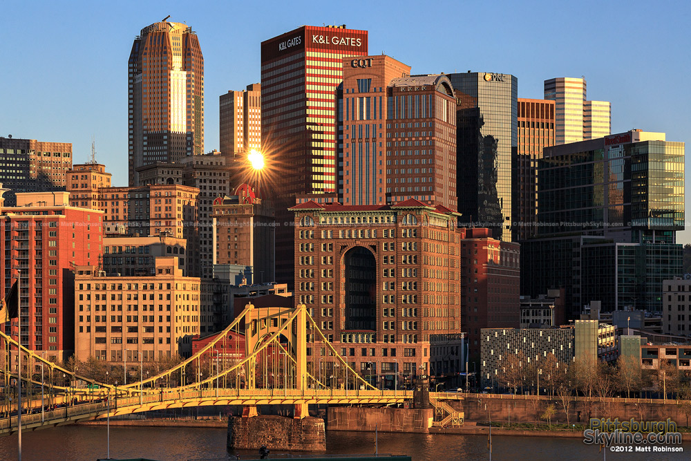 Pittsburgh buildings reflect the setting sun from PNC Park