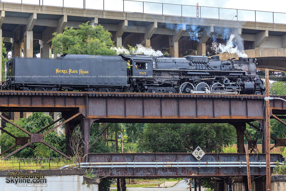 765 crosses a stack of Pittsburgh bridges