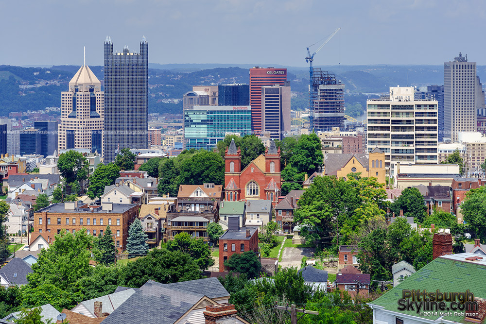 Pittsburgh skyscrapers rise over the surrounding neighborhood of Mt. Washington from the roof of the Prospect School