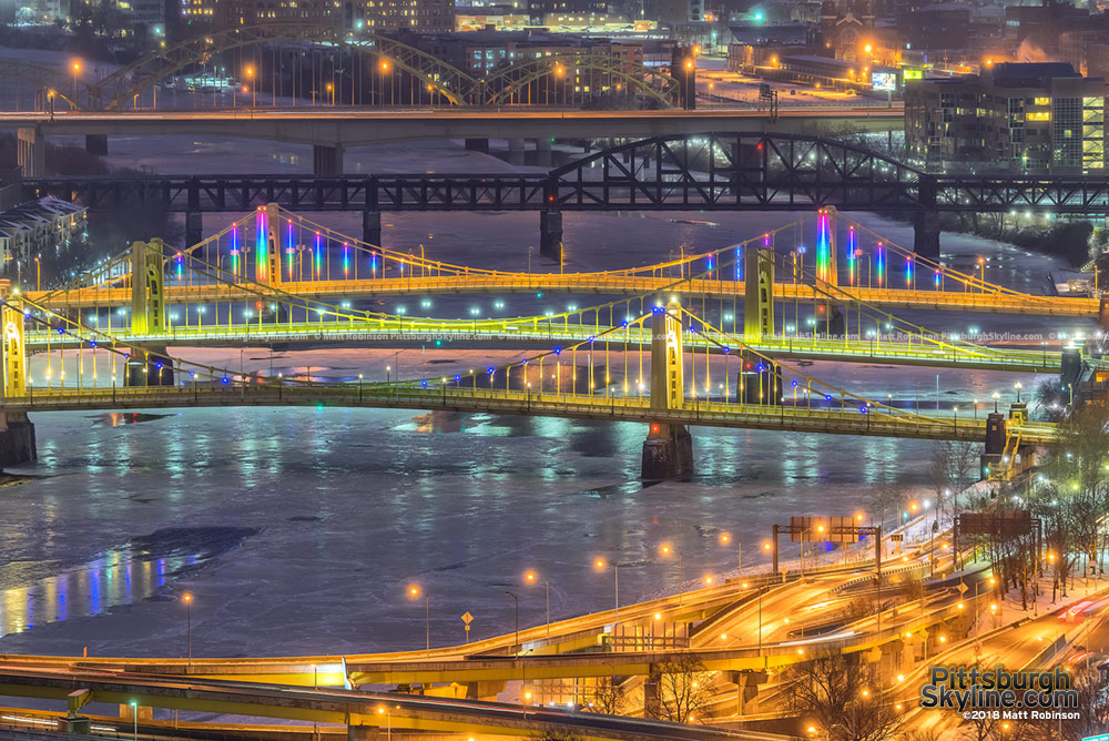 The tree sisters bridges over the icy Allegheny River